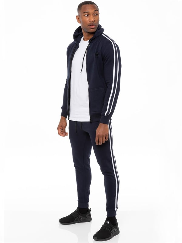 Enzo Mens Tape Hoodie Full Zip Tracksuit. Zip Through Hooded Top. Enzo Embroidery Logo on Chest and Contrast Stripe Design on Sleeves. Hoodie with Drawstring. Ribbed Waist and Cuffs. Kangaroo Pockets. Enzo Mens Casual Designer Striped Tracksuit Joggers. Featuring Classic Contrast Stripes to Sides. 2 Side Pockets. Cotton Blend for Superior Comfort. Adjustable Waist with Drawstrings. Athleisure Perfect for All Gym wear