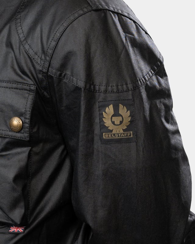 The Racemaster jacket in Faded Olive. There’s more to the Racemaster than meets the eye. Introduced back in 1981, it was originally billed as a shorter version of the iconic Trialmaster. This means that, along with the history, heritage, and dark navy 6 oz. waxed cotton, you also get increased mobility and freedom to move.

6 oz. waxed cotton, with a unique blend of micro and technical waxes
Four external pocket field jacket with reinforcement patches and corduroy details
Water-repellent and wind-repellent
Corduroy linings at the collar, cuffs and hem providing added comfort and resilience at high contact points
Signature antique brass metal hardware with Belstaff England engraved on the round and signature phoenix woven patch on left sleeve
Centre front zip closure with snap closure placket
Buckle-adjusted collar
Two press-stud flap pockets
Two lower zipped pockets
Left internal pocket

Shell: 100% Cotton, Body Lining: 100% CottonSleeve Lining: 55% Polyester, 45% Viscose/Rayon105306