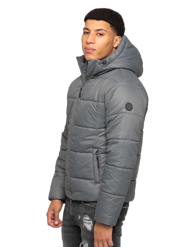 Introducing the Men's Hooded Puffer Jacket—a perfect blend of warmth and style. Featuring a high-neck design and long sleeves. The front zip-up closure offers a sleek and modern look, while the two spacious zipped side pockets provide practicality for carrying essentials. Ribbed cuffs and drawcord hem with adjustable toggle to add to the secure fit, enhancing overall comfort. Crafted from durable materials, this puffer jacket is both functional and stylish, ideal for everyday wear
•	Hooded Puffer Jacket
•	High-neck design
•	Ribbed cuffs
•	Drawcord hem with adjustable toggle