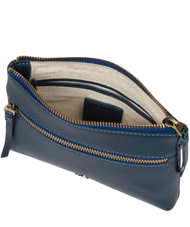The 'Sweetie' cross body bag from Conkca London is handcrafted from multi-toned leather for a beautiful finish. A zip-over top opens to reveal a spacious yet compact main compartment with two slip pockets, lined with natural and untreated 100% cotton. Features a zipped pocket on the front and a slip pouch on the rear, ideal for on-the-go storage. Comes with an adjustable leather strap with a maximum drop length of 70cm. Adorned with the inimitable Conkca squirrel charm and Conkca logos.
