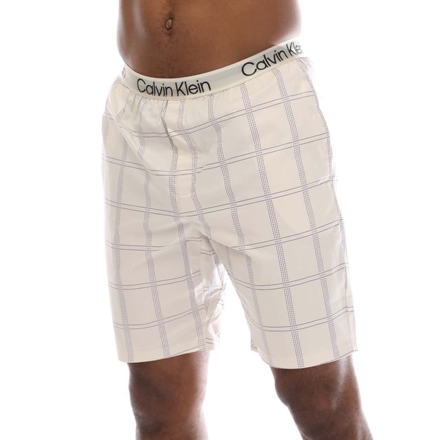 Mens Calvin Klein Shorts Pyjama Set in blue.T-Shirt:- Crewneck.- Short sleeves.- Printed logo.- 57% Cotton  38% Polyester  5% Elastane.Shorts:- Branded elastic waistband.- Side pockets.- Relaxed fit.- 98% Cotton  2% Elastane.- Ref: 000NM2183EO1M