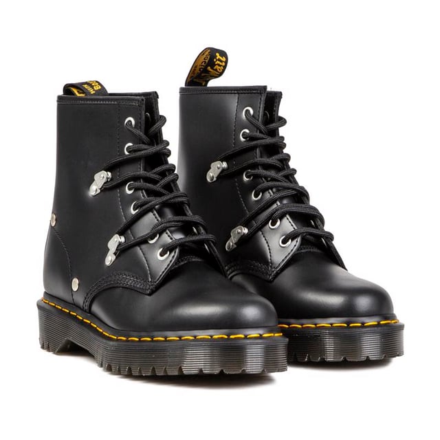 Women's Black Dr. Martens 1460 Pascal Lace-up Boots With A Leather Upper Featuring Standout Metal Studs And Loops Coordinating With 6 Eyelet Lacing System, And Signature Airwair Heel Loop. These Ladies' High-top Boots Have The Iconic Yellow Stitching And Goodyear Welted Air-cushioned Sole With Rugged Tread.