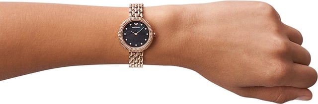 This Emporio Armani Rosa Analogue Watch for Women is the perfect timepiece to wear or to gift. It's Rose Gold 30 mm Round case combined with the comfortable Rose Gold Stainless steel watch band will ensure you enjoy this stunning timepiece without any compromise. Operated by a high quality Quartz movement and water resistant to 3 bars, your watch will keep ticking. This original fashionable watch is set with beautiful stones, perfect for every women. High quality 19 cm length and 12 mm width Rose Gold Stainless steel strap with a Deployment clasp Case diameter: 30 mm,case thickness: 7 mm, case colour: Rose Gold and dial colour: Black