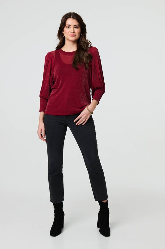 Dress for a smart-casual occasion with this glittery top. It has 3/4 puff sleeves and a hip length hem, along with a round neck and a relaxed fit. Just pair with fitted jeans and heels for the perfect laid-back occasion wear outfit.