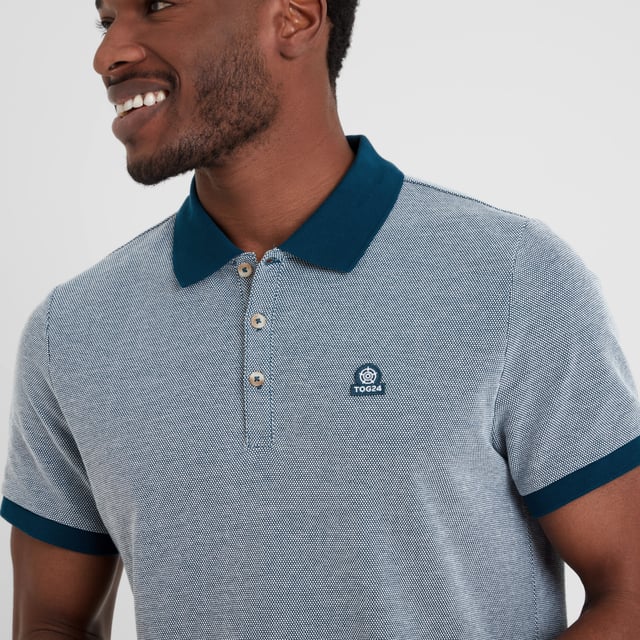Whitley Mens Polo Shirt - Deep Sea Blue Made from comfy and sustainable cotton, TOG24's Whitley pique polo shirt effortlessly blends style with comfort. This polo shirt features branded buttons for an interesting touch of design flair and is made with ribbed cuffs and a ribbed collar for ease of wear.