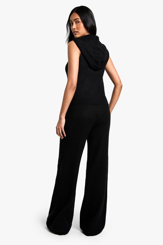 Sleeveless knit hoodie and wide-leg trouser set
        Hooded neckline with adjustable drawstring
        Ribbed knit texture for added interest
        Wide-leg trousers for a relaxed silhouette
        Versatile two-piece design for mix-and-match styling
    
    Embrace laid-back luxury with this chic co-ord set from Boohoo. The sleeveless knit hoodie offers a contemporary twist on athleisure, while the wide-leg trousers create a flowing, elongated silhouette. Perfect for casual outings or lounging at home, this set can be dressed up or down with ease. Pair with trainers and a crossbody bag for a trendy daytime look, or style with heeled mules and statement earrings for an evening out with friends. The ribbed knit texture adds a tactile element, making this set both comfortable and stylish. For cooler days, layer a long-sleeved top underneath the hoodie or throw on an oversized denim jacket. The versatility of this co-ord allows for endless styling possibilities, making it a must-have addition to your wardrobe.