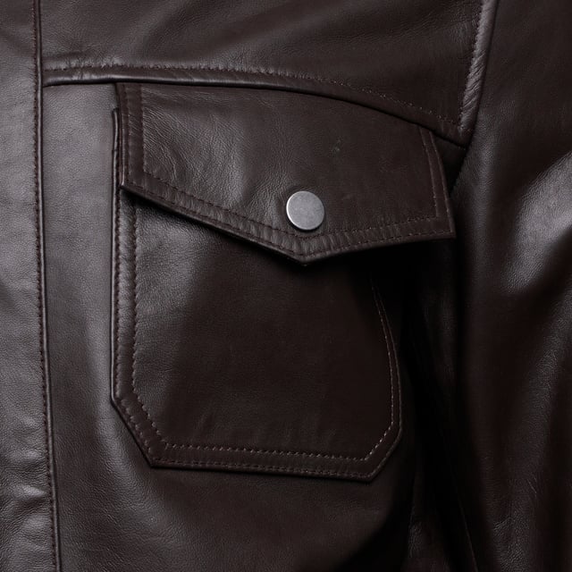 Introducing the Barneys Originals Brown Leather Harrington jacket - a timeless piece crafted for the modern adventurer. With its rich brown hue and classic Harrington silhouette, this jacket exudes rugged sophistication. Perfect for any occasion, whether you're exploring the city streets or unwinding in the countryside, it's the epitome of versatile style and enduring quality.