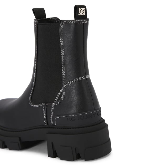 This KG Kurt Geiger Trekker Chelsea boot features a black upper with white stitching detail. There are two elasticated panels on the ankle.