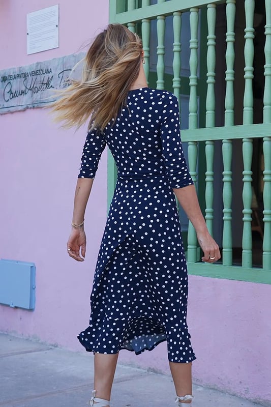 REASONS TO BUY:

The dress that feels as good as it looks
Super-comfy fabric
Chic navy polka dot print
Flattering V-neck and waist tie
Feminine ruffle hem
We're wearing it with a white blazer and wedges