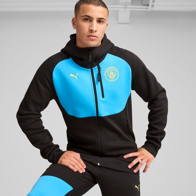 PUMA Mens Manchester City PUMATECH Full-zip Hoodie PRODUCT STORY: Show your City team spirit in style. This full-zip hoodie keeps you comfortable and warm. With moisture-wicking dryCELL technology and side pockets for your essentials, you'll stay focused on the game. Victory never looked so good. FEATURES & BENEFITS: dryCELL: Performance technology designed to wick moisture from the body and keep you free of sweat during exercise; Made with at least 20% recycled materials. DETAILS: Regular fit; 320 gsm, Knitted; Long sleeves; Zipped side and chest pockets; Zipped, front and side pockets. Our model is 185 cm tall and is wearing size M UK.