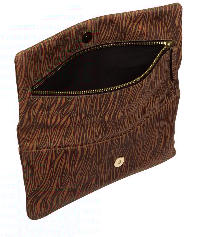 The 'Amelia' clutch bag from the Pure Luxuries Marylebone collection is handcrafted from high-quality, genuine Nappa leather with a natural super-soft touch. The fold-over top conceals a zip-top that opens to reveal the main compartment that is lined with 100% cotton. The fold-over top is secured by a magnetic press stud and features gold-coloured metal fittings and zip. The Pure Luxuries logo is embossed in gold foil for a beautifully simple finishing touch.