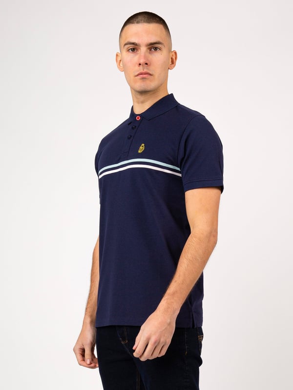 This polo shirt from LUKE is perfect for your everyday line-up. It's crafted from a soft cotton pique and detailed with yarn dyed contrast stripes across the chest. It features a classic button placket which has a contrast colour underside and is complete with the brand's iconic lion head embroidery on the left chest. Iconic LUKE BLACK, GOLD, RED lion head embroidery. Iconic LUKE tri-colour trim tape. LUKE buttons. Contrast yarn dyed chest stripes. Rib collar and cuff. Contrast colour underside of collar.