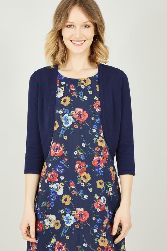 Layer up with this Navy Knitted Bolero for those cooler summer nights. Finished in a luxuriously soft feeling, navy colour. This little number is perfect to layer over a sleek dress for a fancy event to keep you looking sophisticated, or over a pretty floral number for the cooler summer nights. To complete your chic look, wear this cardigan with a floral dress, sandals and sunglasses.