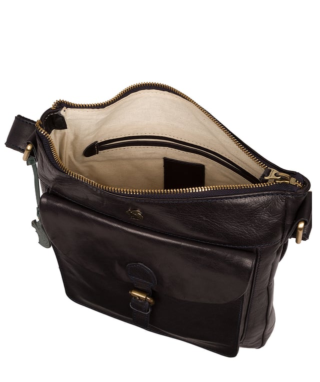 The 'Josephine' shoulder bag from Conkca London is crafted from vegetable-tanned leather for a richly textured finish. The zip-over top conceals a gorgeous, 100% natural, untreated cotton lining and two interior pockets. Featuring a mock buckle, the exterior pocket provides plentiful on-the-go storage. Comes with an adjustable fabric strap and is furnished with gold-coloured metal fittings. Adorned with the inimitable and charming Conkca London squirrel charm and logo for an eye-catching finish.