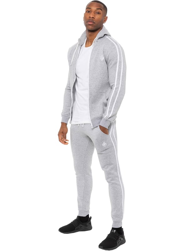 Enzo Mens Tape Hoodie Full Zip Tracksuit. Zip Through Hooded Top. Enzo Embroidery Logo on Chest and Contrast Stripe Design on Sleeves. Hoodie with Drawstring. Ribbed Waist and Cuffs. Kangaroo Pockets. Enzo Mens Casual Designer Striped Tracksuit Joggers. Featuring Classic Contrast Stripes to Sides. 2 Side Pockets. Cotton Blend for Superior Comfort. Adjustable Waist with Drawstrings. Athleisure Perfect for All Gym wear