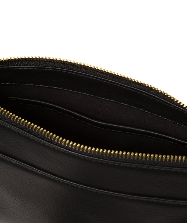 Handcrafted from Nappa leather, the 'Monica' cross body bag from the Pure Luxuries London Marylebone Collection elevates this classic design. A spacious main compartment is secured under a zip-over top which is lined with 100% cotton for a luxurious feel. Two slip pockets on the interior of the bag provide additional storage space - ideal for maintaining an organised accessory. Complementing the interior storage is a stylish pocket secured with a press-stud fastener made to look like a buckle reminscent of the classic satchel design. Gold-coloured metal fittings and zips adorn the bag alongside the slim and adjustable leather strap with a maximum drop length of 65cm. The Pure Luxuries logo is embossed in gold foil for a beautifully simple finishing touch.