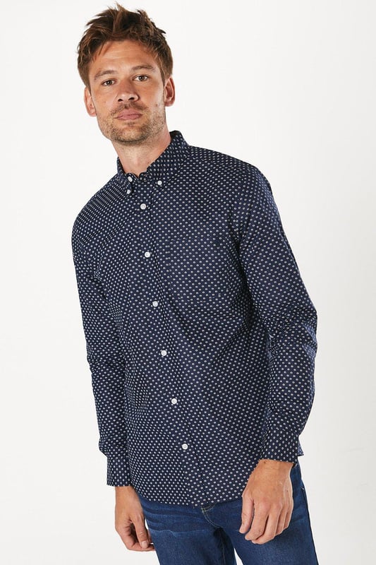 Striking geometric print for a modern twist on classic shirting
        Button-down collar for a smart-casual look
        Long sleeves with adjustable cuffs for versatile styling
        Chest pocket adds a functional touch
        Regular fit allows for comfortable movement
    
    This Maine geo print long sleeve shirt is a versatile addition to any wardrobe, perfect for those seeking a balance between style and comfort. The eye-catching geometric pattern adds interest to your ensemble without overwhelming it, making it suitable for various casual occasions. Pair it with your favourite jeans and trainers for a relaxed weekend look, or dress it up with chinos and loafers for a smart-casual dinner out. The cotton fabric ensures breathability and ease of care, ideal for the busy modern man. Layer it under a jumper on cooler days or wear it open over a plain t-shirt when the weather warms up. Whether you're heading to a family gathering, meeting friends at the pub, or enjoying a casual day at the office, this shirt will keep you looking effortlessly stylish.