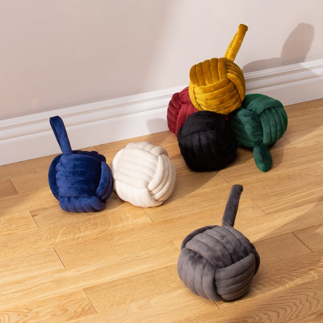 Solve the knotty problem of keeping a door open with this beautifully designed door stop. Soft, durable entwined luxury plush velvet cleverly creates a knot-shape, complete with a handle which makes it easy to pick up after use and store. Filled with sand and polyester for extra strength, this door stop makes a quirky addition to your home.