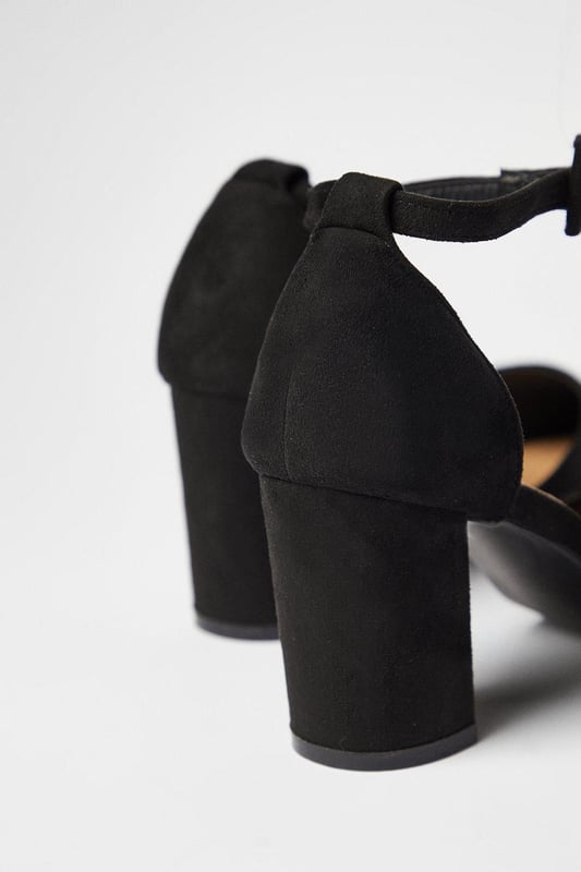 Pointed toe design for a sleek, elongating effect
        Covered block heel for stability and comfort
        Ankle strap with adjustable buckle closure
        Wide fit construction for enhanced comfort
        Versatile high heel height between 7 and 9cm
    
    Step out in style with these versatile court shoes, perfect for the fashion-forward woman who values both comfort and elegance. The wide fit construction ensures a comfortable wear throughout the day, while the pointed toe adds a touch of sophistication to any ensemble. Whether you're heading to the office or meeting friends for brunch, these shoes effortlessly transition from day to night. Pair them with tailored trousers and a crisp blouse for a polished work look, or dress them up with a flowing midi skirt for evening drinks. The ankle strap adds a secure fit and a trendy touch, making these shoes a must-have for your wardrobe. Ideal for various occasions, from baby showers to dinner dates, these court shoes offer the perfect blend of style and practicality for the modern woman.
