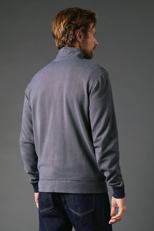 Birdseye textured fabric for a subtle, sophisticated look
        Full-length zip closure for versatile styling options
        Stand-up collar adds a refined touch
        Ribbed cuffs and hem for a snug fit
        Side pockets for practicality and hand warmth
    
    The Maine Birdseye Zip Through Sweat seamlessly blends comfort with style, making it a versatile addition to any casual wardrobe. The textured birdseye fabric adds depth and interest to this otherwise classic design, setting it apart from standard sweatshirts. Perfect for those laid-back weekend outings or casual Friday at the office, this sweat can be easily dressed up or down. Pair it with dark wash jeans and white trainers for a smart-casual look, or layer it over a crisp shirt for a more polished ensemble. The full-length zip allows for adaptable styling, whether fully zipped for a sleek silhouette or left open for a more relaxed vibe. Ideal for British weather, this sweat is your go-to for those unpredictable days when you need an extra layer without compromising on style. From family gatherings to casual meetups with friends, this Maine sweat ensures you're always comfortably stylish.