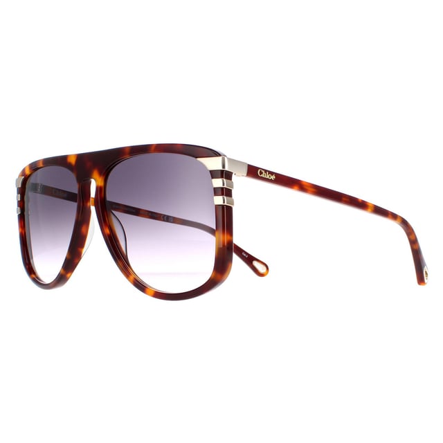 Las gafas de sol Chloe CH0104S 007 en degradado gris habana medio brillante son un moderno estilo aviador fabricado en acetato ligero. El logotipo de Chloe está grabado en las patillas finas para reconocer la marca.