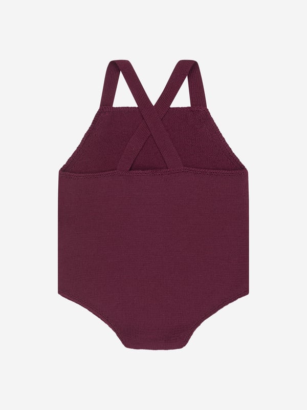 A charming rompersuit designed for your little one by luxury label Bonpoint. The rich purple suit is constructed from soft wool with a crossover back and delicate button fastenings on the straps. Layered up or worn alone, this is a timeless piece for your baby.