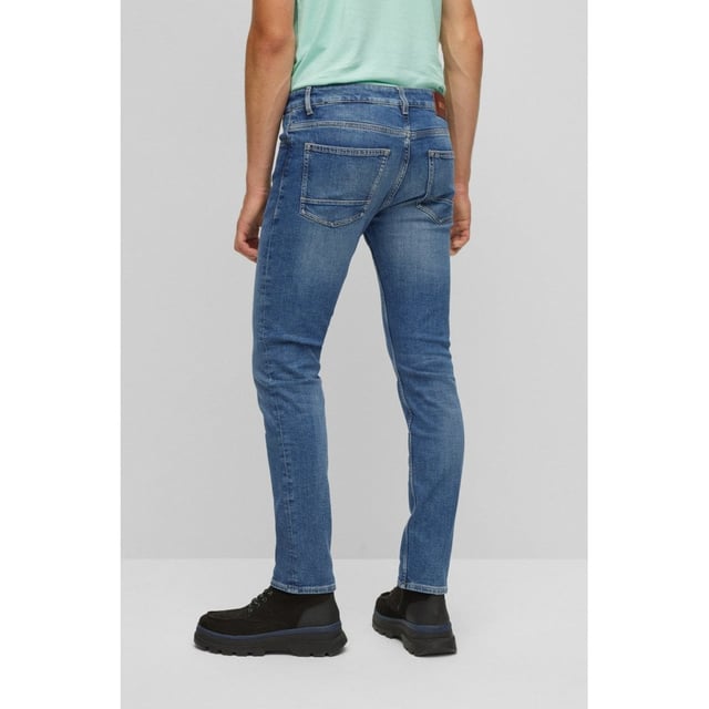 Five-pocket jeans by BOSS Menswear with signature trims and an authentic lived-in look. Delivered in a dark-blue tone for year-round styling, these jeans are cut to a narrow fit with a regular rise in comfort-stretch denim for lasting shape recovery. For our RESPONSIBLE products, we always use at least 60% more sustainable raw materials. This garment is made from at least 60% certified organic cotton. Organic cotton is only grown with naturally occurring substances and no genetically modified seeds. Organic farming encourages the use of natural measures, such as crop rotation and composting, to control pests and diseases rather than relying on chemicals.
Slim fitRegular riseButton and zip closurePockets bottom front: Side pocketsSlim legPockets bottom back: Patch pocketStandard lengthFit foot width: 36,0 cm
90% Cotton, 8% Polyester (recycled) , 2% Elastane
50471138