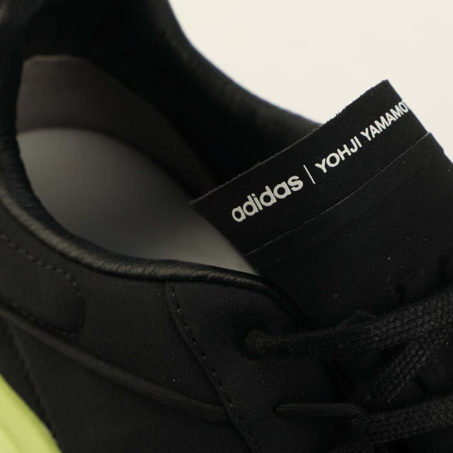 Mens Y-3 Shiku Run Trainers in black yellow.- Leather upper.- Lace closure.- Padded ankle.- Tonal pull-tab.- Round toe.- Contrasting printed logo on the tongue.- Embossed logo on the inside.- Moulded sole.- Ref: GZ9139