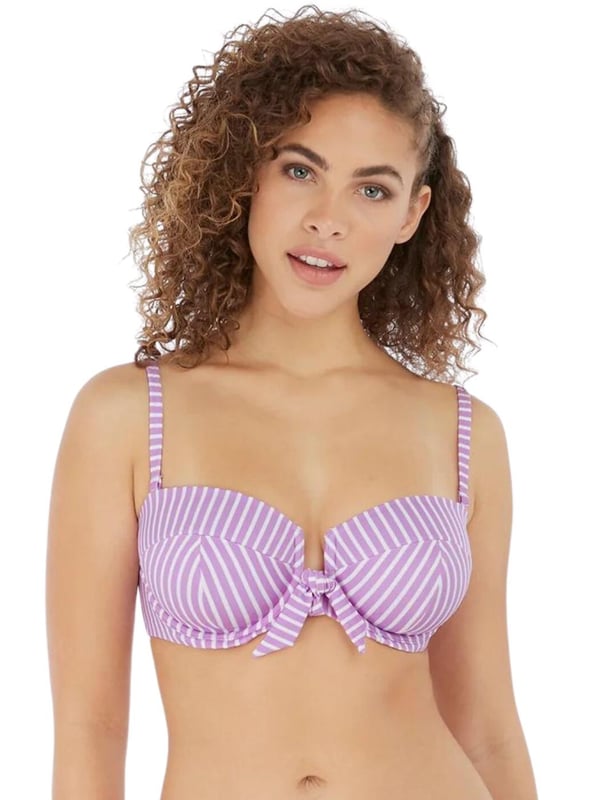 Freya's Beach Hut bandeau bikini top is versatile and chic, with adjustable straps that can be converted from straight to cross-over, or removed for the perfect look no matter what you are doing. The cups are underwired for support and lightly padded, giving your bust a smooth, round shape. The rear clip fastening will stay secure all-day long for worry-free wear. The chic knot detail and open-centre front design add a feminine, flirty touch.  Underwired, Lightly padded, Adjustable straps, Clip fastening, Front knot detail, Open-centre front, Removable, convertible straps, Country of origin: Sri Lanka, Composition: 69% Polyamide | 16% Elastane | 15% Polyester, Listed in UK sizes.   Bandeau Bikini Top