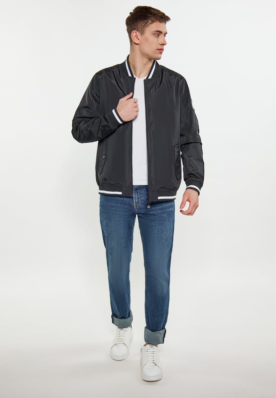 Een bomberjack voor wie op zoek is naar een perfecte mix van stijl en functionaliteit. Deze jas heeft een ritssluiting aan de voorkant die loopt van de onderkant tot aan de kraag voor een veilige pasvorm. De geribbelde structuur bij de kraag zorgt voor een extra vleugje verfijning en wordt aangevuld met contrasterende streepdetails. De geribde elastische banden bij de manchetten en onderzoom zijn vervaardigd met oog voor detail en hebben bijpassende strepen voor een samenhangende look. Met twee voorzakken met knoopsluiting biedt deze jas handige opbergmogelijkheden zonder dat dit ten koste gaat van de stijl. De ingezette mouwen en de normale schoudernaad zorgen voor een comfortabele pasvorm  college jack