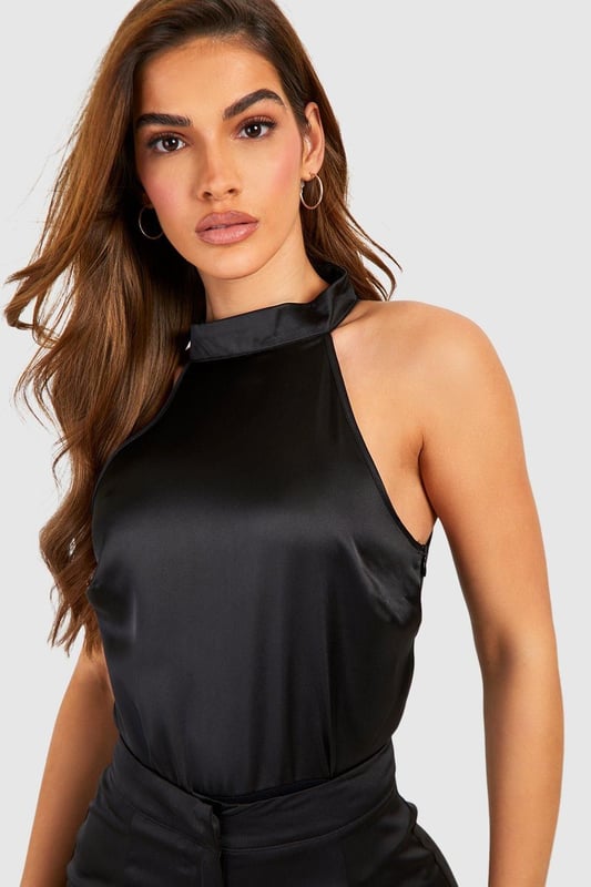 Covering up has never looked so good thanks to our fire high neck bodysuit range. Featuring a high neckline that's perfect for colder months, a long sleeve turtleneck bodysuit is a must have in every wardrobe. Comfortable, versatile, and a perfect base layer for any outfit, pair yours with some high waisted split-hem jeans and barely there heels to be style inspo. Give luxe vibes in a frill sleeve high neck body or make a statement in an animal print mesh number. Style: BodysuitDesign: PlainFabric: WovenLength: RegularNeckline: High NeckSleeve Length: Sleeveless