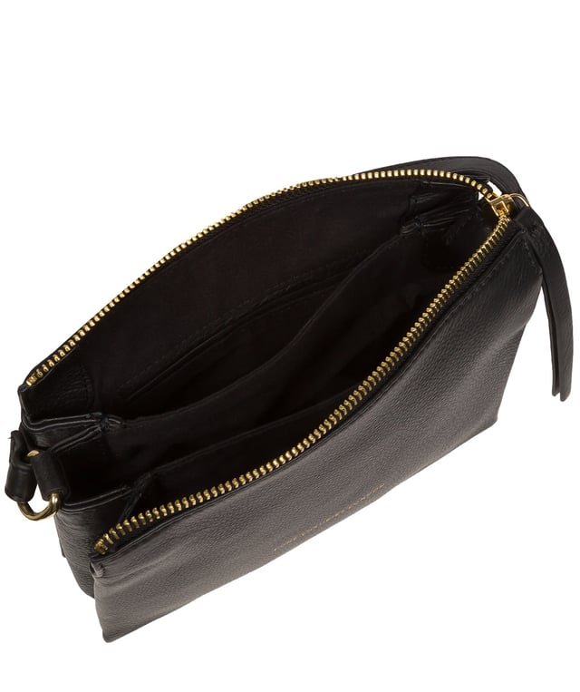 The 'Niki' cross body bag from the Pure Luxuries Marylebone collection is handcrafted from high-quality, genuine Nappa leather with a natural super-soft touch. The zip-over top opens to reveal a 100% cotton-lined interior. The spacious interor features three divided sections, a slip pocket and three card slots. The slip pocket on the rear of the bag provides on-the-go storage and comes with a matching and adjustable slim leather strap with a maximum drop length of 65cm. The Pure Luxuries logo is embossed in gold foil for a beautifully simple finishing touch.