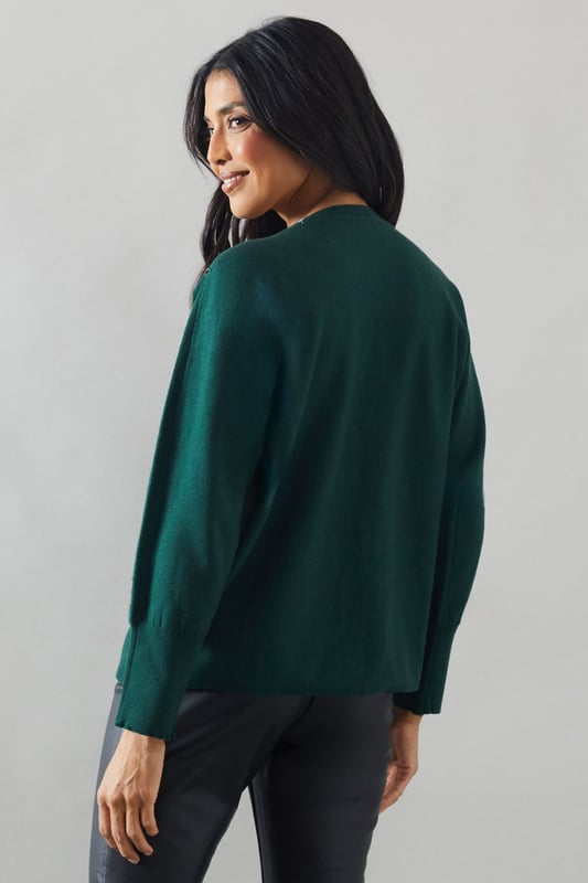 Boat neck design for a sophisticated silhouette
        Stud detailing along neckline and shoulders for added glamour
        Relaxed fit through the body for comfort
        Long sleeves for versatile styling
        Ribbed cuffs and hem for a polished finish
    
    This Wallis jumper seamlessly blends comfort with sophistication, making it a versatile addition to your wardrobe. The boat neck design creates an elegant neckline, while the stud detailing adds a touch of glamour to elevate your look. Perfect for casual events or family gatherings, this jumper can be styled effortlessly for various occasions. Pair it with sleek trousers and ankle boots for a chic daytime ensemble, or dress it up with a statement necklace and heels for evening drinks. The relaxed fit ensures all-day comfort without compromising on style, allowing you to feel at ease whether you're running errands or enjoying a leisurely brunch with friends. This jumper is a testament to Wallis' commitment to creating pieces that are both fashionable and functional, catering to the modern woman who values both style and comfort in her everyday attire.