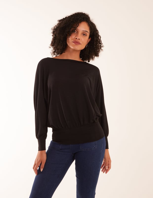 Doesn't matter if you are going to work or a late-night cocktail with friends, you will not go wrong with the batwing top. You can match this top with wide leg jeans and short heel boots.