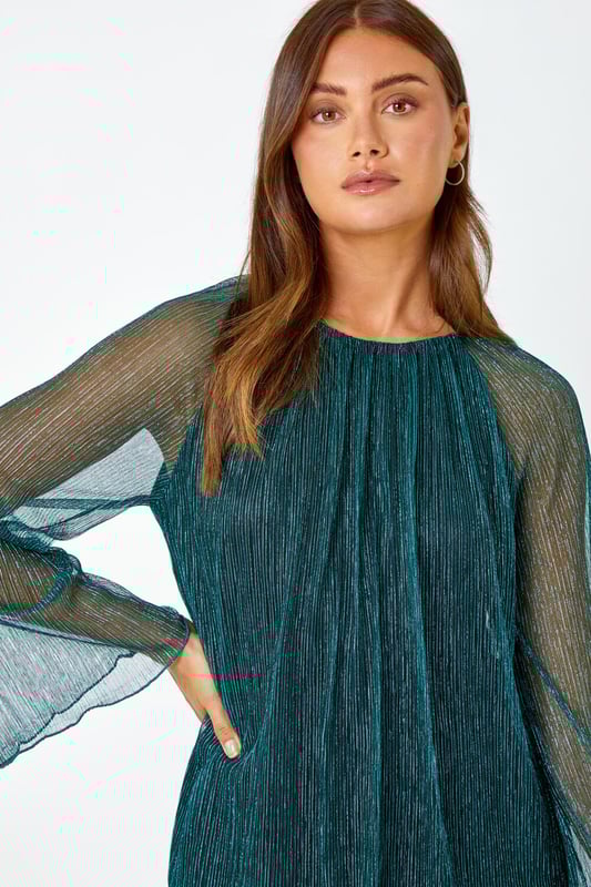 Plisse Overlay Wide Sleeve Top from Roman. Party all night in this plisse top! Cut from a glistening shimmer fabric, this top features a modest round neckline and extravagant wide sleeves to create a playful yet sophisticated style. Designed with a fitted underlay to keep you covered this top features a flirty keyhole cutout that accentuates the button fastening at the back of the neck. Pair with faux leather trousers and strappy heels and you’re sure to be the star guest at all of this season's parties!