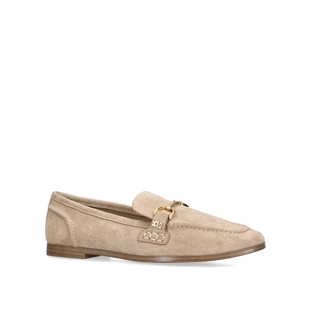 The KG Kurt Geiger Madeline is a taupe microsuede slip on loafer. There is an antiqued brass horse bit chain across the toe and small KG Kurt Geiger stud.
