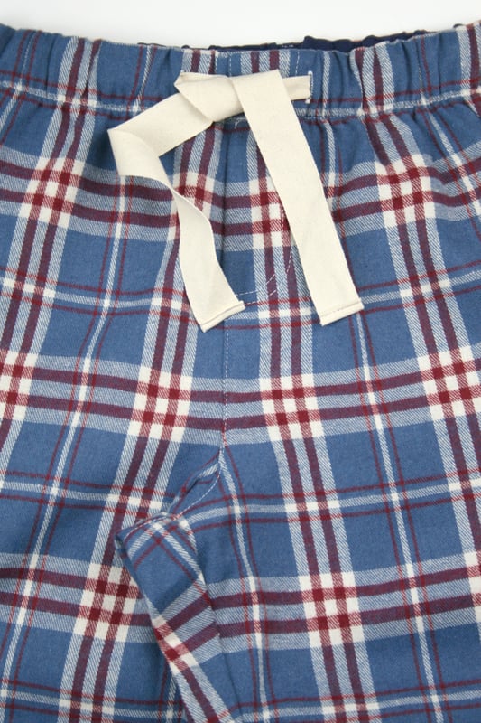 Discover the perfect blend of style and comfort with our ladies' cotton check lounge pants. Crafted from soft, breathable 100% cotton, these PJ bottoms are designed for ultimate relaxation and everyday wear. The classic checkered pattern adds a stylish touch to your loungewear, making them versatile for indoor lounging or quick errands. With an elastic waistband and adjustable drawstring and side pockets, they offer a flexible fit for any body type.  These lounge pants are easy to pair with any top. Enjoy cosy, fashionable comfort all day!