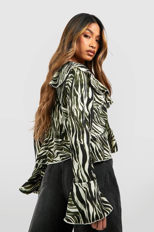 A loose-fitting, lightweight garment with a feminine feel, a blouse is the ultimate wardrobe staple that never goes out of style. Floaty, chic, and far from basic, go from day to night with this classic piece. Whether you choose a floral blouse with jeans for a low-key vibe or drop jaws with a classic satin blouse and trousers, you'll be reaching for this style season after season. Seen in updated prints and classic neutrals, we're talking minimal effort, maximum payoff.Style: BlouseDesign: AnimalFabric: PolyesterLength: RegularNeckline: V NeckSleeve Length: Long SleeveModel's height: 173cm / 5'8"