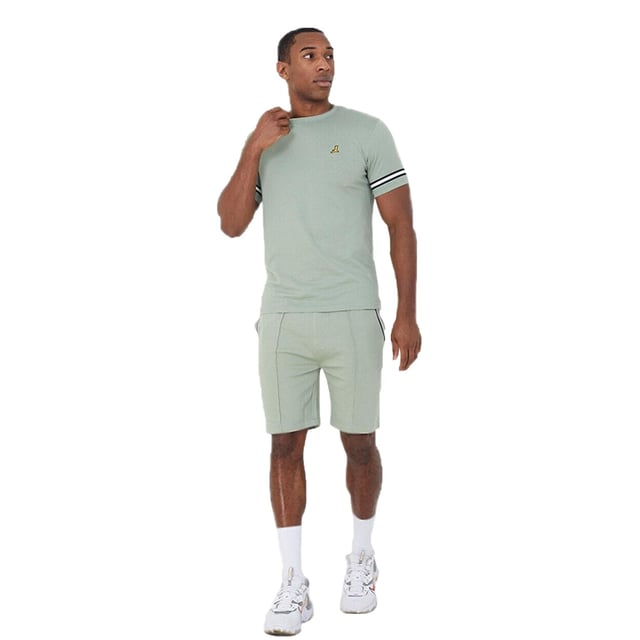 Get ready to embrace endless comfort and style this season with this t-shirt and shorts set from Brave Soul. Crafted from 100% cotton, the crew neck t-shirt features tape detail on the sleeves and embroidery detail on the chest. The matching shorts are made from a soft cotton blend and feature pintuck detail and two waist pockets. This set is the ultimate addition to your casual wardrobe. Model wears UK size M.