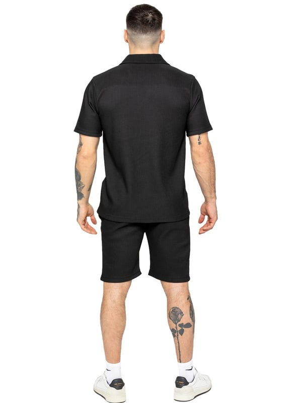 Elevate your summer style with our Enzo Milano Men's Outfit Set, including a textured ribbed revere shirt and relaxed fit shorts. Experience ultimate comfort with a button fastening and adjustable drawstring waistband, while looking effortlessly stylish with a revere collar and single back welt pocket. Made with premium fabric, this set is perfect for any occasion.