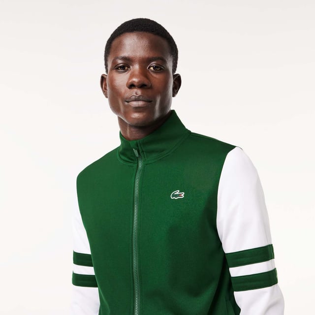 Designed for Tennis  for a regular frequency of use This product is in Interlock which guarantees you a resistant fabric making it adapted to high repetitive movements during training sessions. This sweatshirt is made in 100% recycled polyester and has 2 zipped hand pockets to secure your personal items. Classic fit: comfortable ease on body  with comfortable sleeves The technical capsule offers the complete seasonal wardrobe on and off court with a strong design identity. LACOSTE wording print at back neckline.