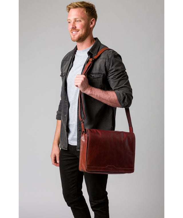 Handcrafted from full-grain natural leather, the 'Zico' messenger bag from Conkca London comes with a robust finish. The handsome accessory features a fold-over top secures a spacious central compartment which is lined with natural, untreated 100% cotton lining alongside rustic metal fittings and zips. Ample storage space is provided by a padded laptop pocket on the interior. Comes with an adjustable strap with a maximum drop length of 70cm and adorned with the handsome Conkca leather label.