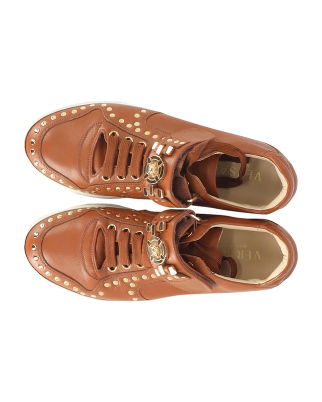 VINTAGE, RRP AS NEW
Brimming with fabulous details, these Versace sneakers are crafted from leather into a low-top silhouette and feature lace-up vamps, gold-tone studs and the Medusa logo on the ankle straps. Comfortable soles and trendy appeal make these sneakers a must-buy.
Versace Medusa Studded Low Top Sneakers in Tan Leather
Condition: very good
Sign of wear: light dirt on soles, minimal creasing on exterior
SKU: 245398   
Color: brown | tan
Material: Leather
Size: IT40/EU40/UK7/US10