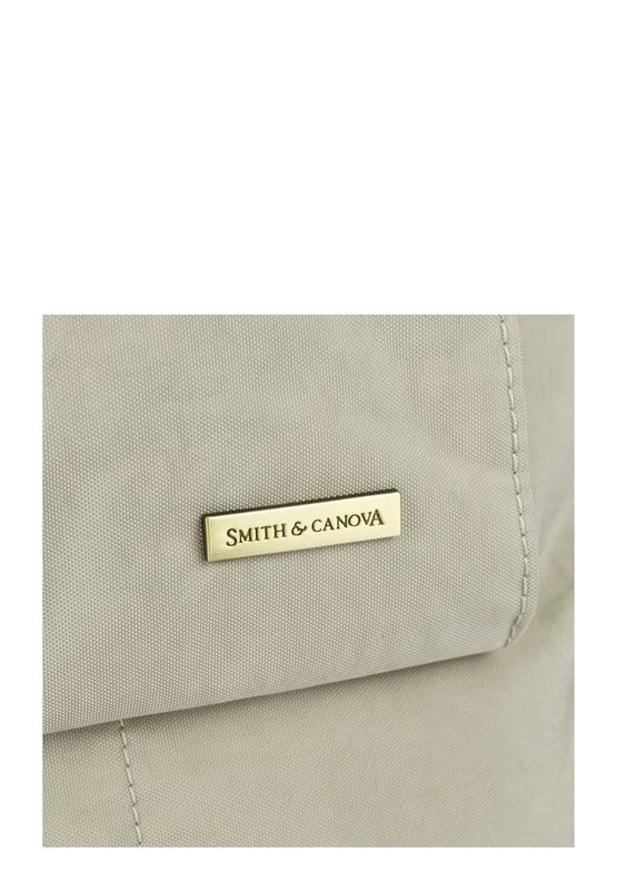 Made from our signature nylon, the Portrait Nylon Tote is the perfect way to carry all your everyday essentials. Featuring a padded carry handle and adjustable crossbody strap with a clip off function. Features: , Zip top opening, Front oversized flap over zip pocket, Rear zip pocket, SMITH & CANOVA antique brass logo, Branded antique brass zips, Padded grab handle, Adjustable crossbody strap (detachable), Internal 15 inch padded laptop sleeve, Internal zip pocket, 2 Internal mobile phone slip pockets - fits normal and plus size smart phones, 2 Internal pen slip pockets Style Ref: 92682 STONE