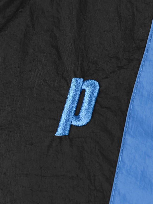 A casual but sporty baseline track jacket by Prince Off Court. This jacket features gel print Prince on the sleeves with contrast blue stripes on the front body of the jacket and on the sleeves. Made with 100% nylon with a gel print. Wash on a delicate cycle. Be sure to turn it inside out to protect the gel print letters.