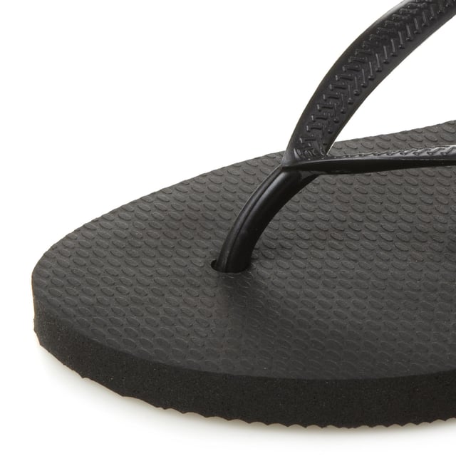 Embrace the summer in this casual flip flop by Havaianas. Slim fit design with white sole and toe post. Sizing is an adjusted fit meaning the foot fits to the edge of the sole.