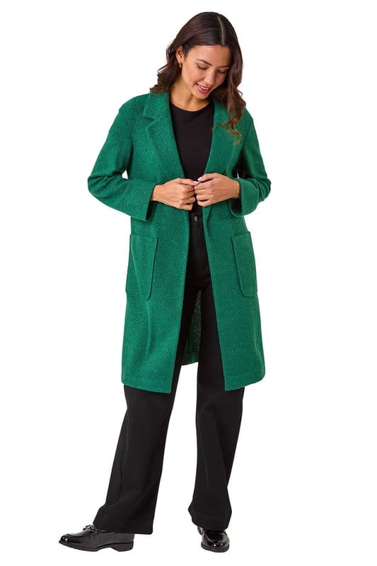 Boucle Knit Longline Coatigan from Roman. Add a timeless classic to your collection with this coatigan. Designed in a classic longline shape this piece features a relaxed rever collar, edge to edge opening and cosy full-length sleeves. This coatigan is the perfect addition to your wardrobe for the transitional season. Dress it up or down to suit any occasion, this versatile piece also features patch pockets. Pair this jacket with a pair of jeans and a high-neck jumper for an ultra-cosy finish!