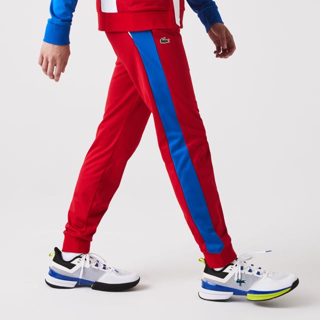 Men's Lacoste SPORT Run-Resistant Tennis Trackpants.- Regular fit, natural ease: The perfect fit for workouts.- Drawstring waist: Customised comfort and fit.- Contrast print on side: The iconic Lacoste colour-block.- Rigid crocodile sewn onto front: Quintessentially Lacoste.- Recycled polyester run-resistant piqué: Lightweight. Environmentally friendly. Material: 100% Polyester. Ref: XH9427W50.