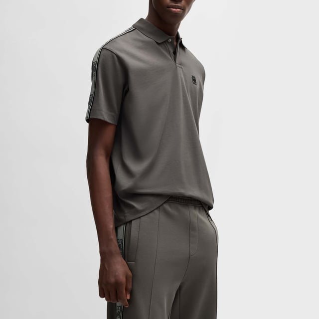 Mens Hugo X RB Branded Tape Polo Shirt in grey.- Polo collar.- One button placket.- Short sleeves.- Branded tape on the sleeves and a chest logo.- Relaxed fit.- Ref: 50530101069