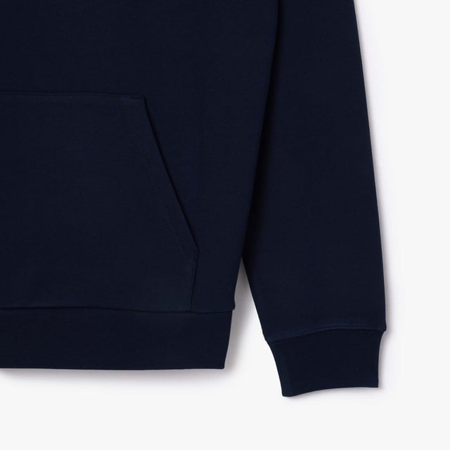 Own the french fashion sport Hoodie in French Terry Raglan sleeves Kagaroo pocket Knot drawcord 55x53 cm felt badge with Lacoste Paris embroidery and green crocodile on chest.